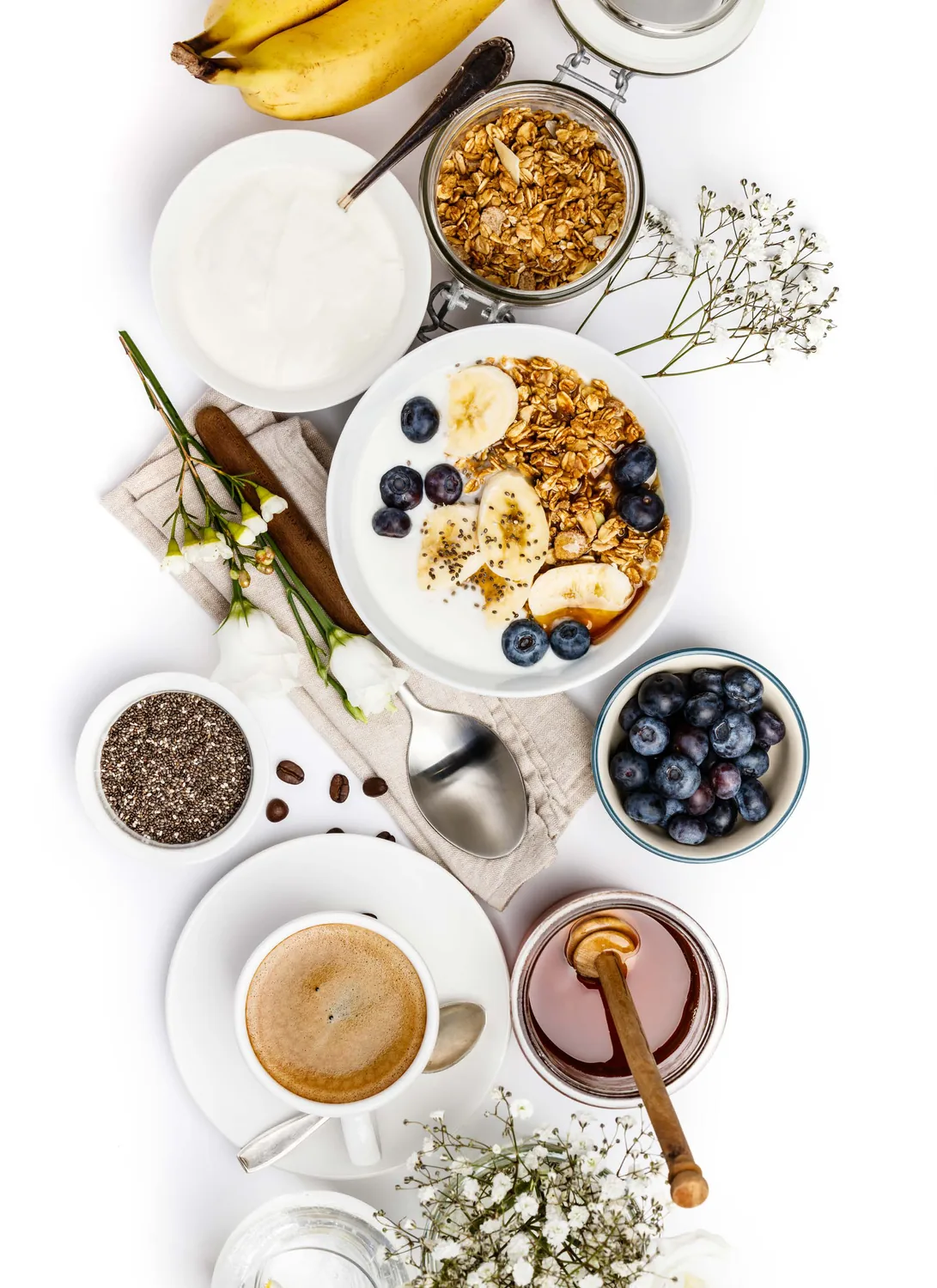A breakfast spread of granola, fruit, honey and coffee